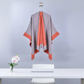 Gray and coral cape hanging in office with flower